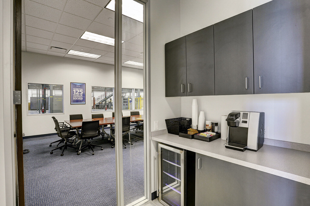 Comfortable kitchenette area with seating in Emerson Network Power office in Houston, TX