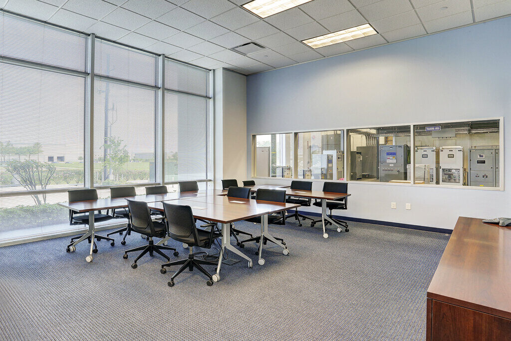 Spacious conference room with large windows in Emerson Network Power office renovation project in Houston, TX