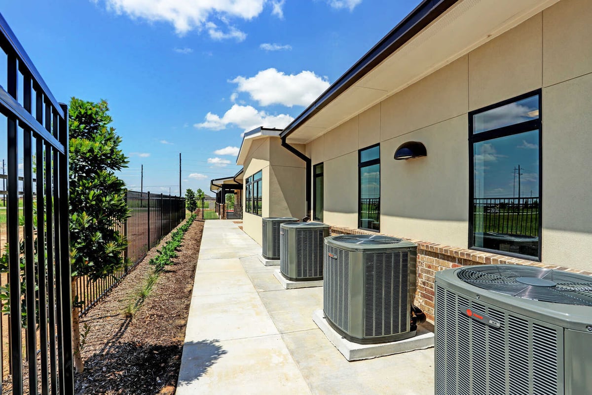 Exterior view showcasing HVAC units along the building wall, part of GSD Construction’s Houston, TX project