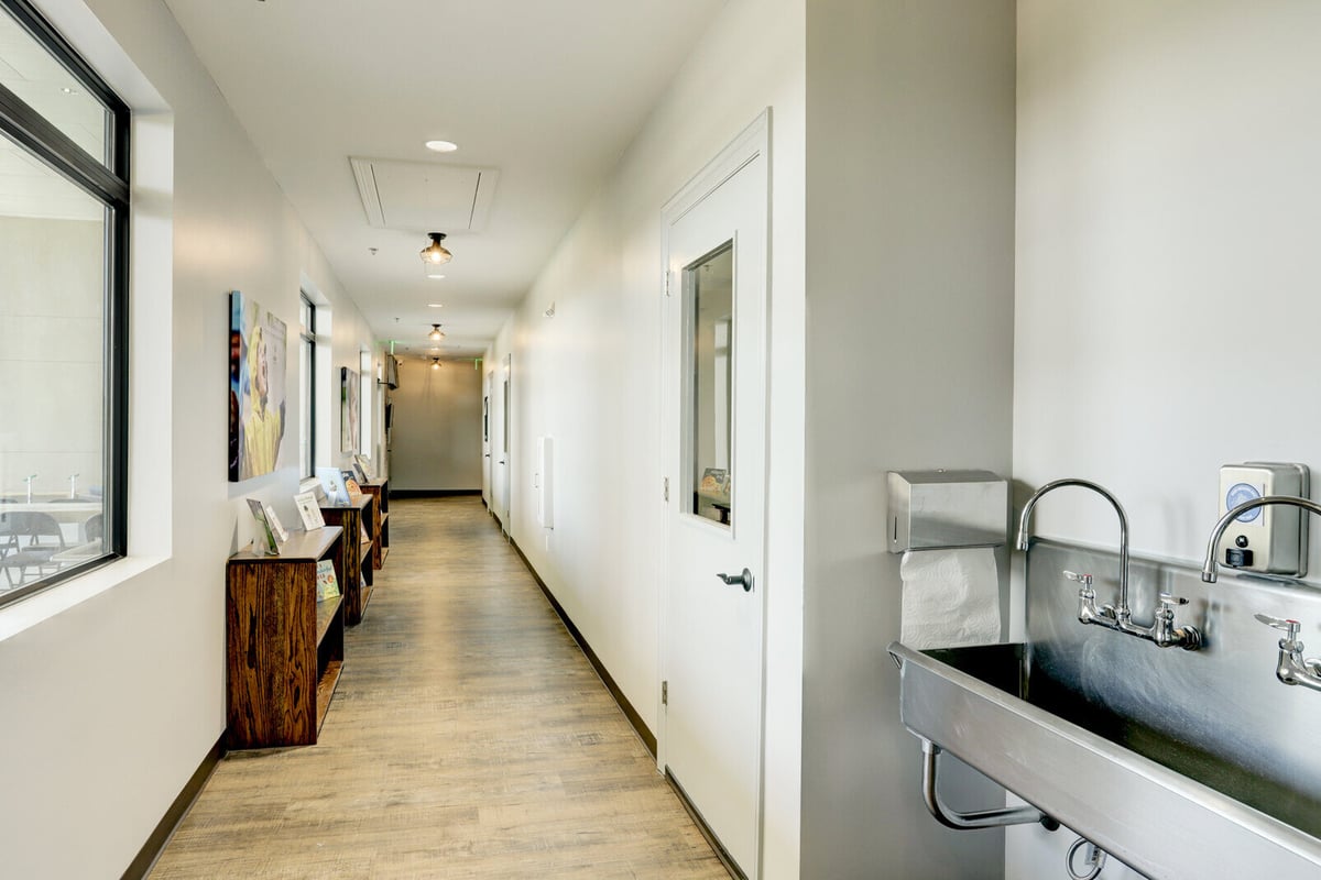 Hallway with a handwashing station and modern decor, part of GSD Construction’s renovation in Houston, TX
