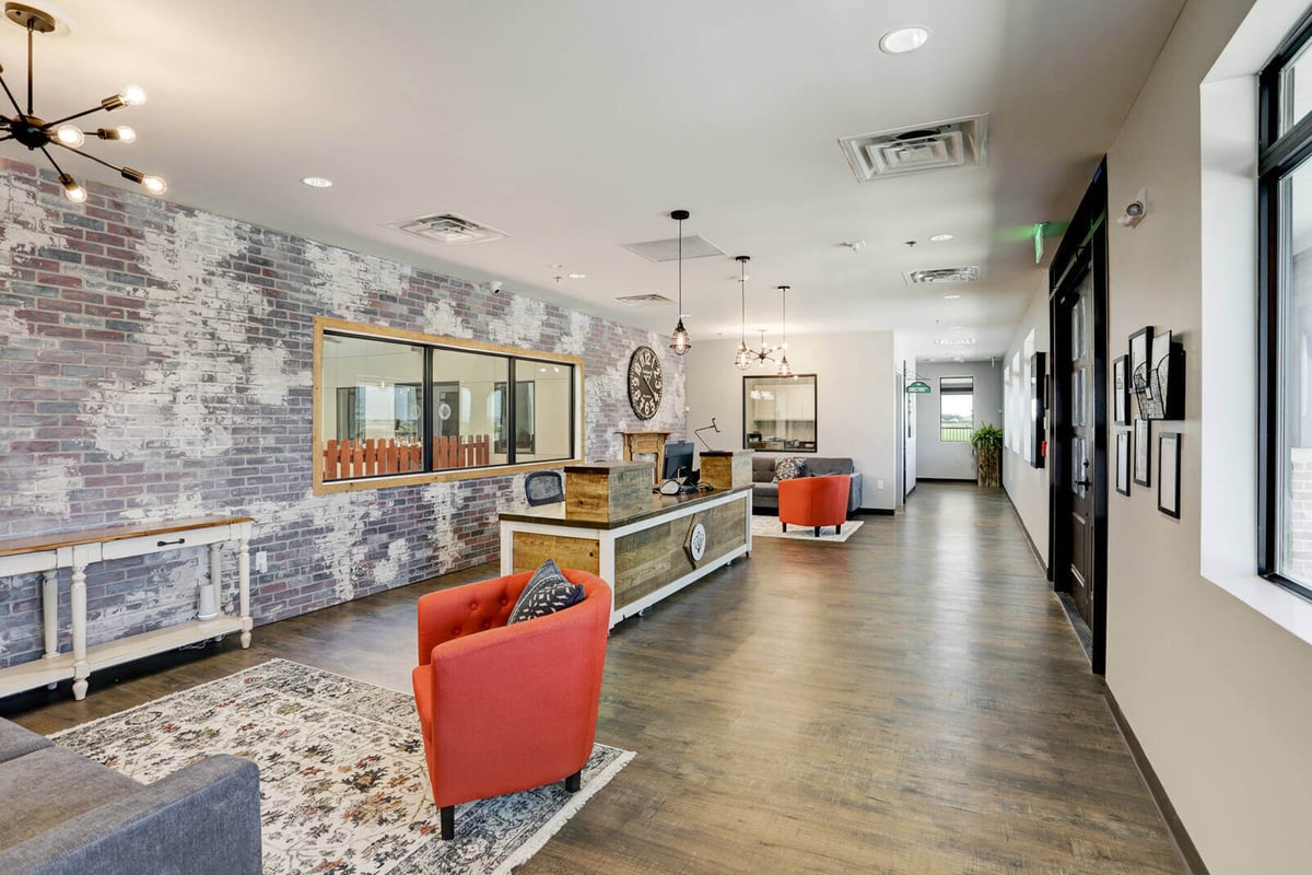 Modern lobby interior with rustic wood decor and exposed brick walls, renovated by GSD Construction in Houston, TX