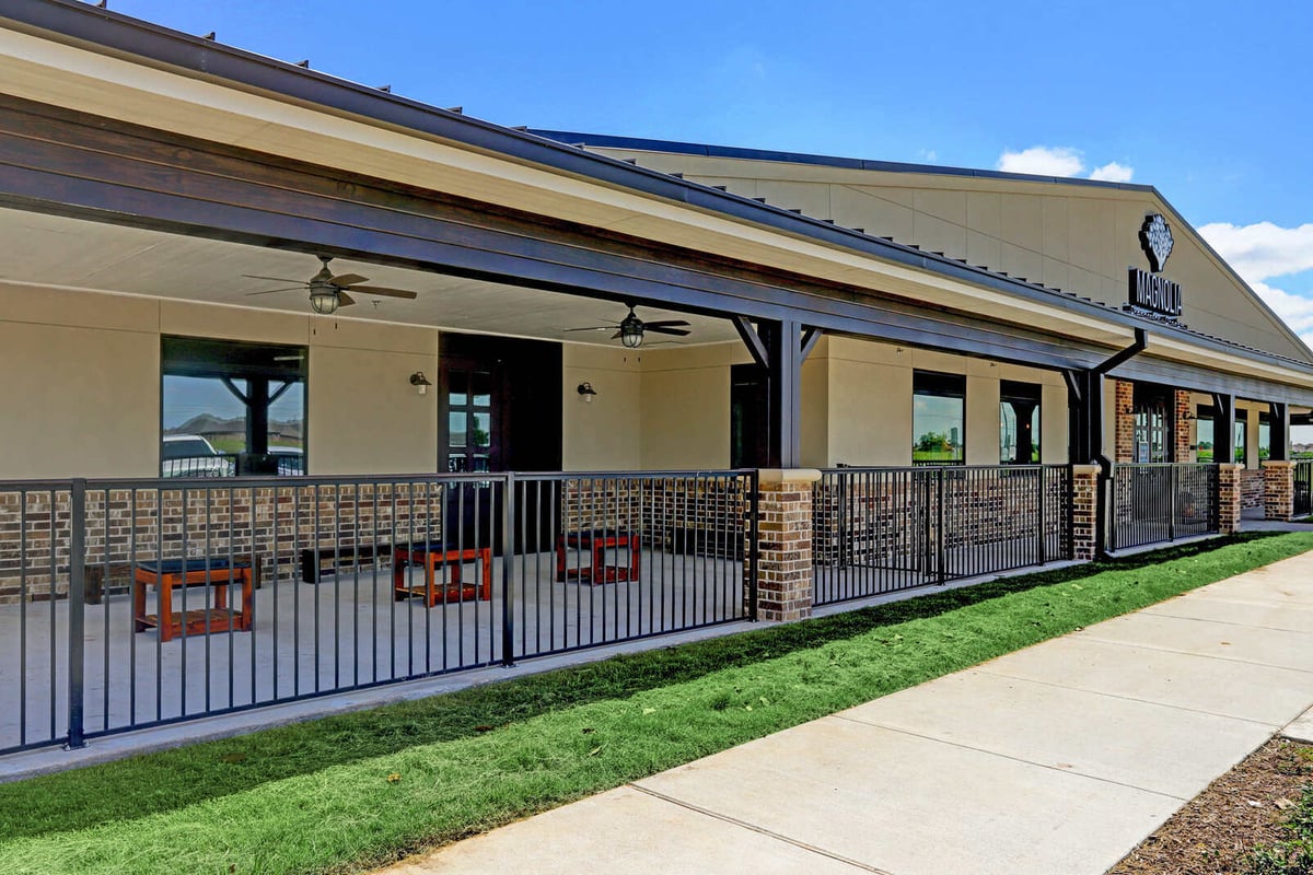 Newly landscaped outdoor area with a playground and seating, part of a commercial renovation by GSD Construction in Houston, TX