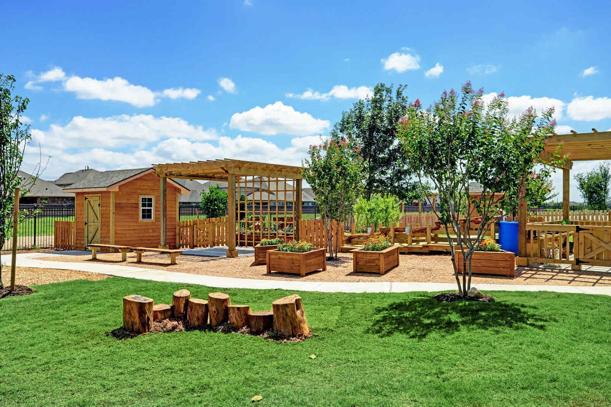 Outdoor garden area with wooden pergolas and planter boxes, part of GSD Construction’s Houston, TX project