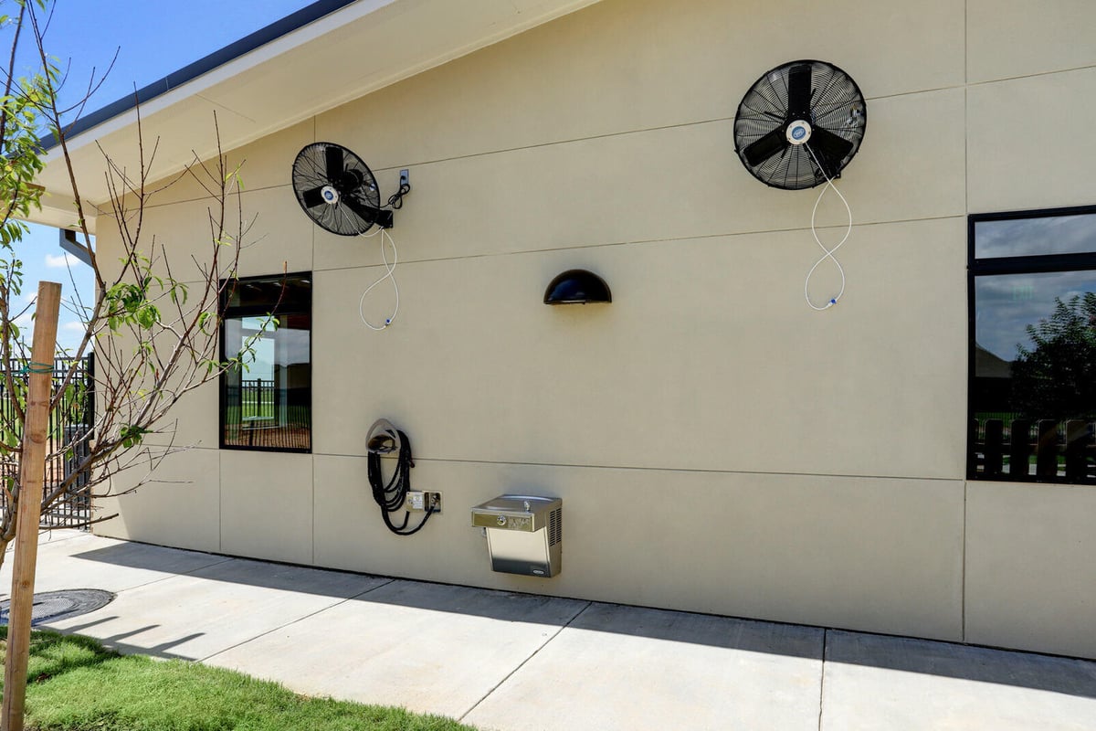 Side exterior wall with mounted fans, part of a commercial renovation by GSD Construction in Houston, TX