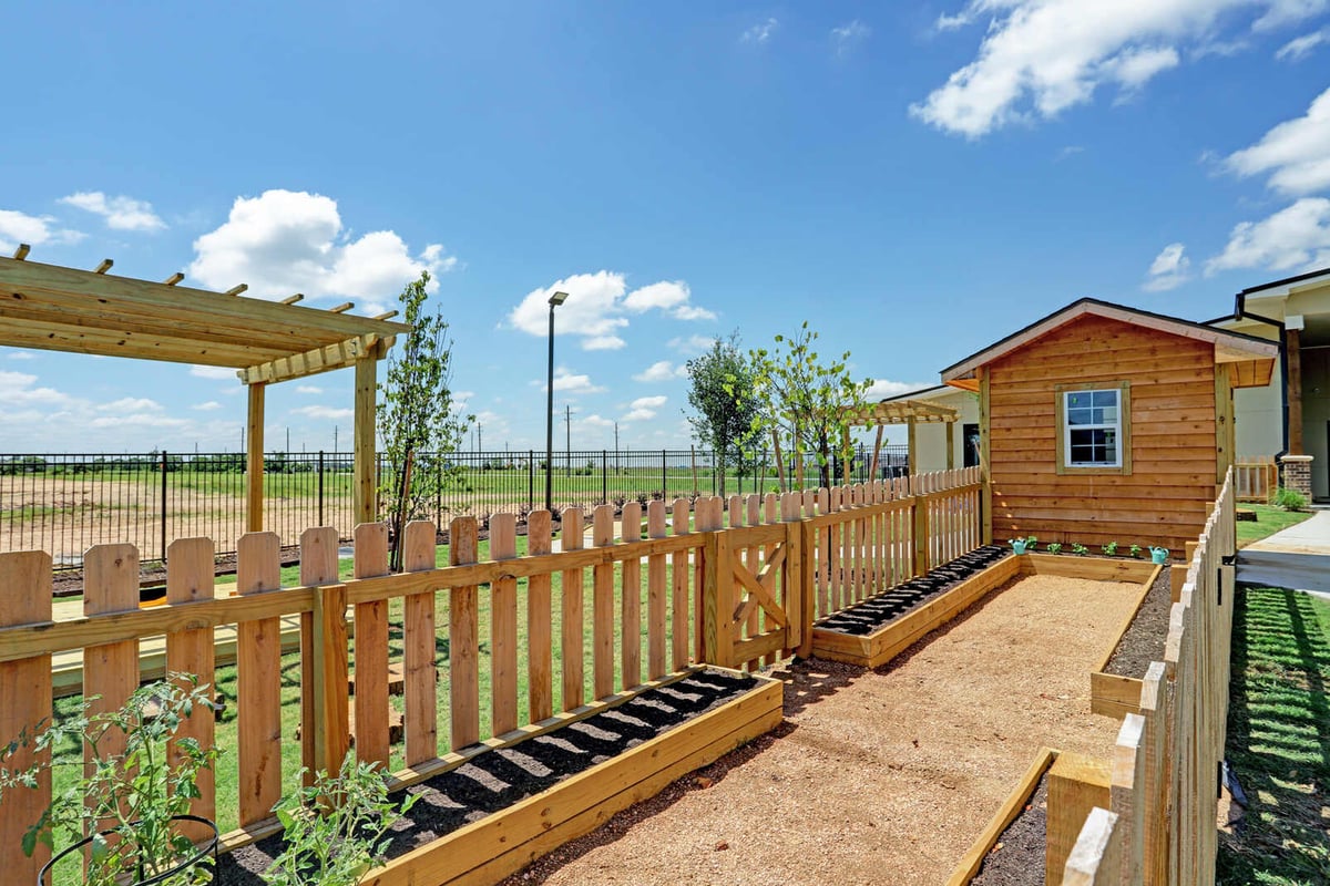 Wooden fenced garden with planter boxes, part of GSD Construction’s outdoor renovation in Houston, TX