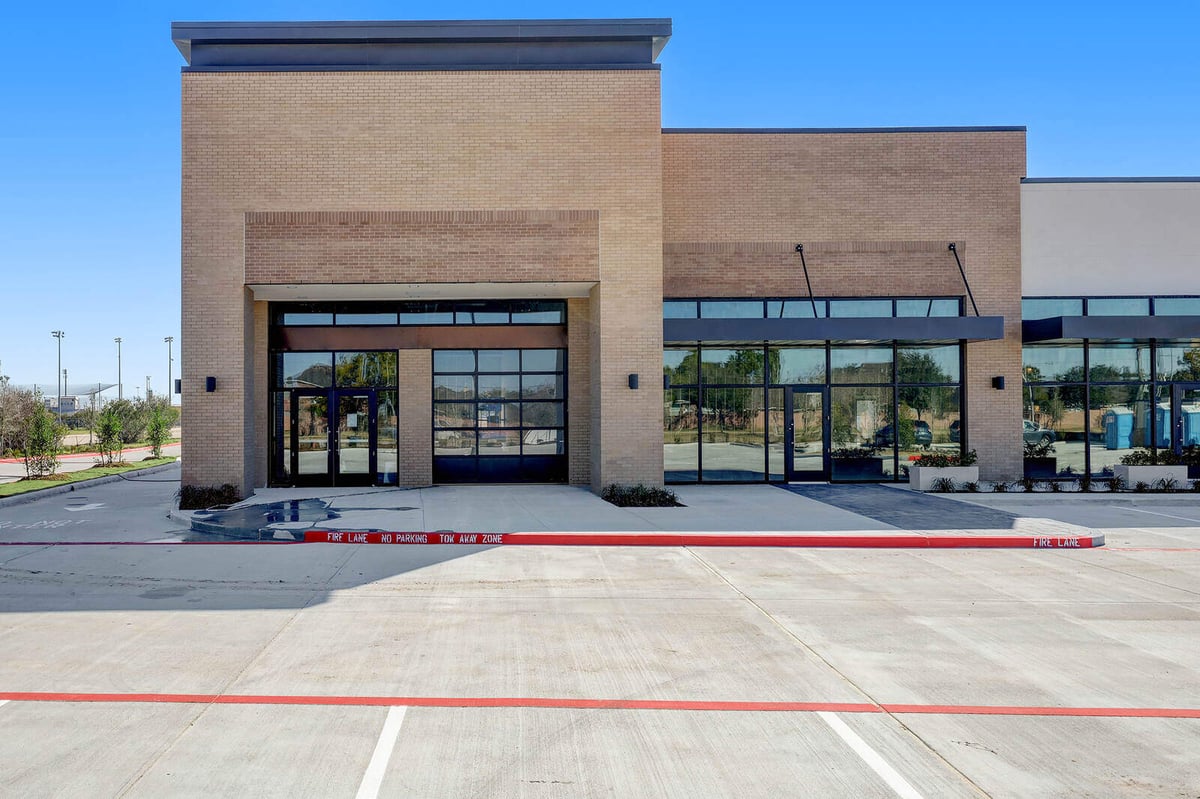 Front view of a newly developed commercial property with large windows and modern design in Houston, TX