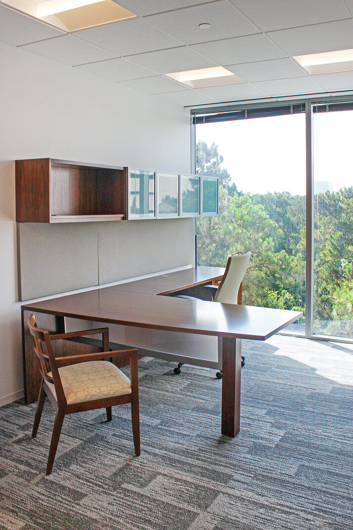 Executive office featuring modern furniture and a large window view, renovated by GSD Construction in Houston, TX